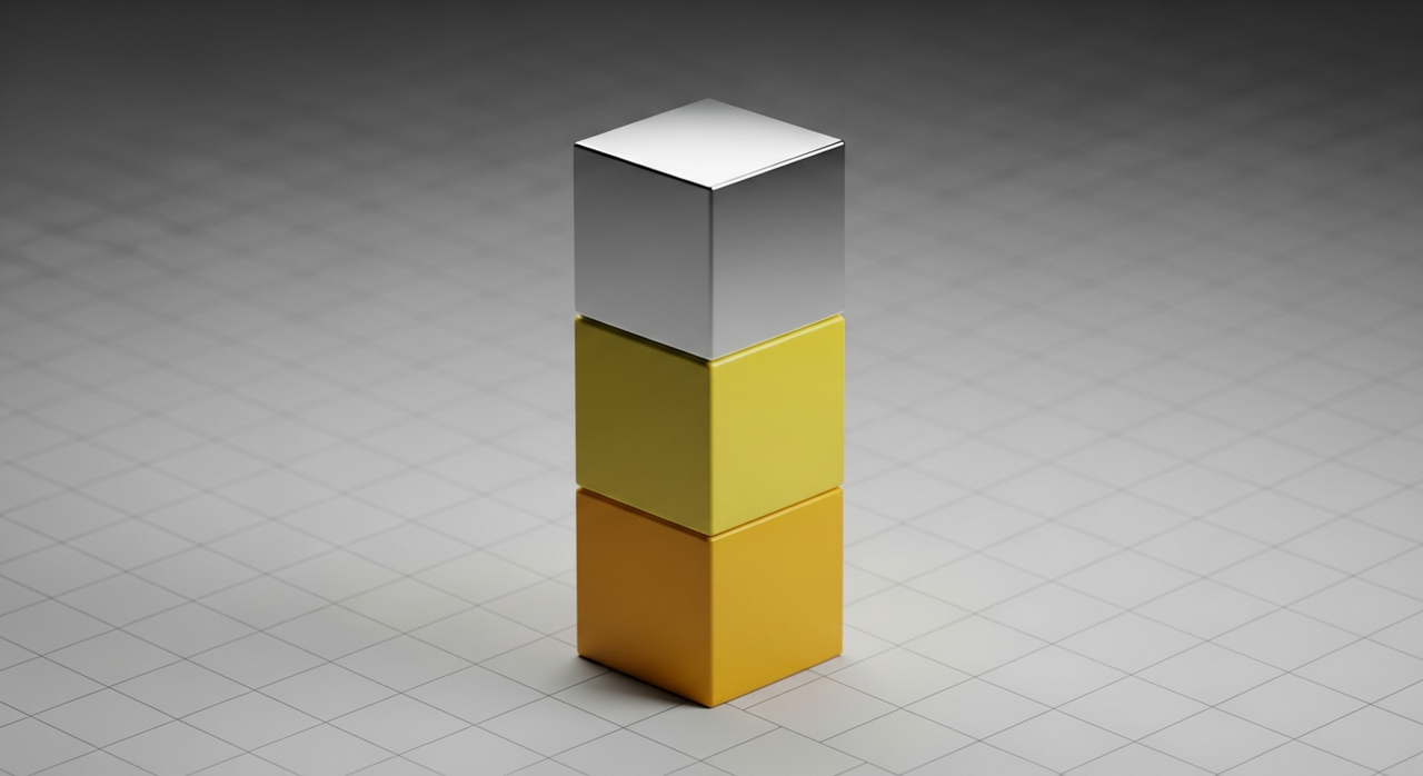 Three perfectly stacked cubes, one silver, two yellow, on a grid surface.